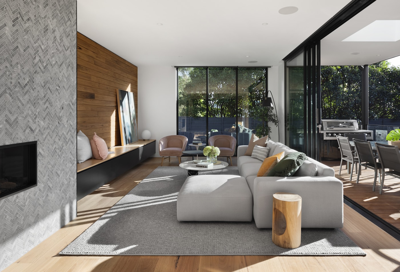 Luxury living room with stone fireplace, timber details and garden views