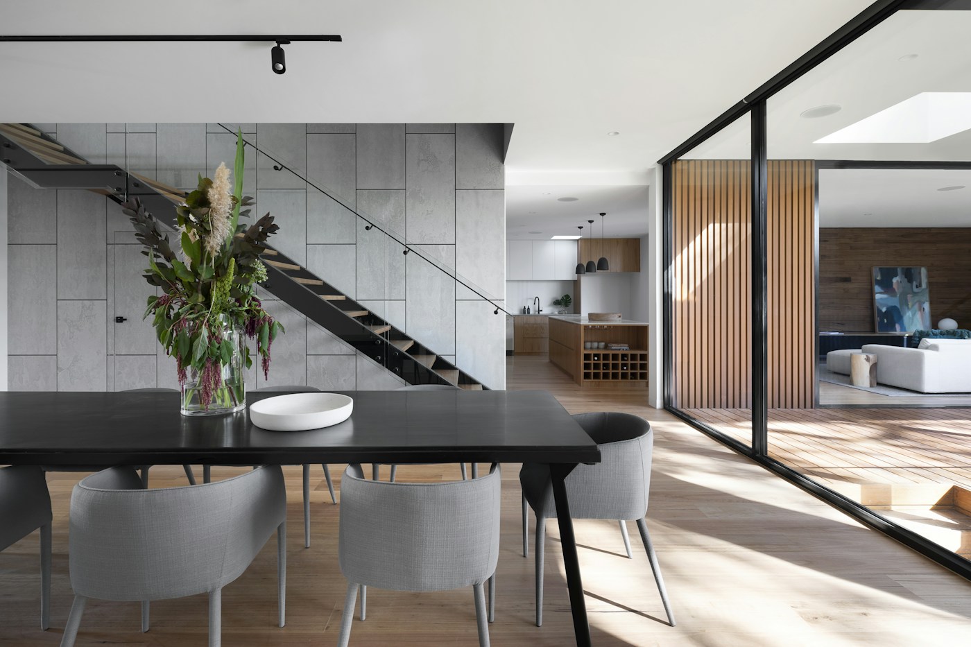 Architect-designed kitchen with stone island and warm timber finishes