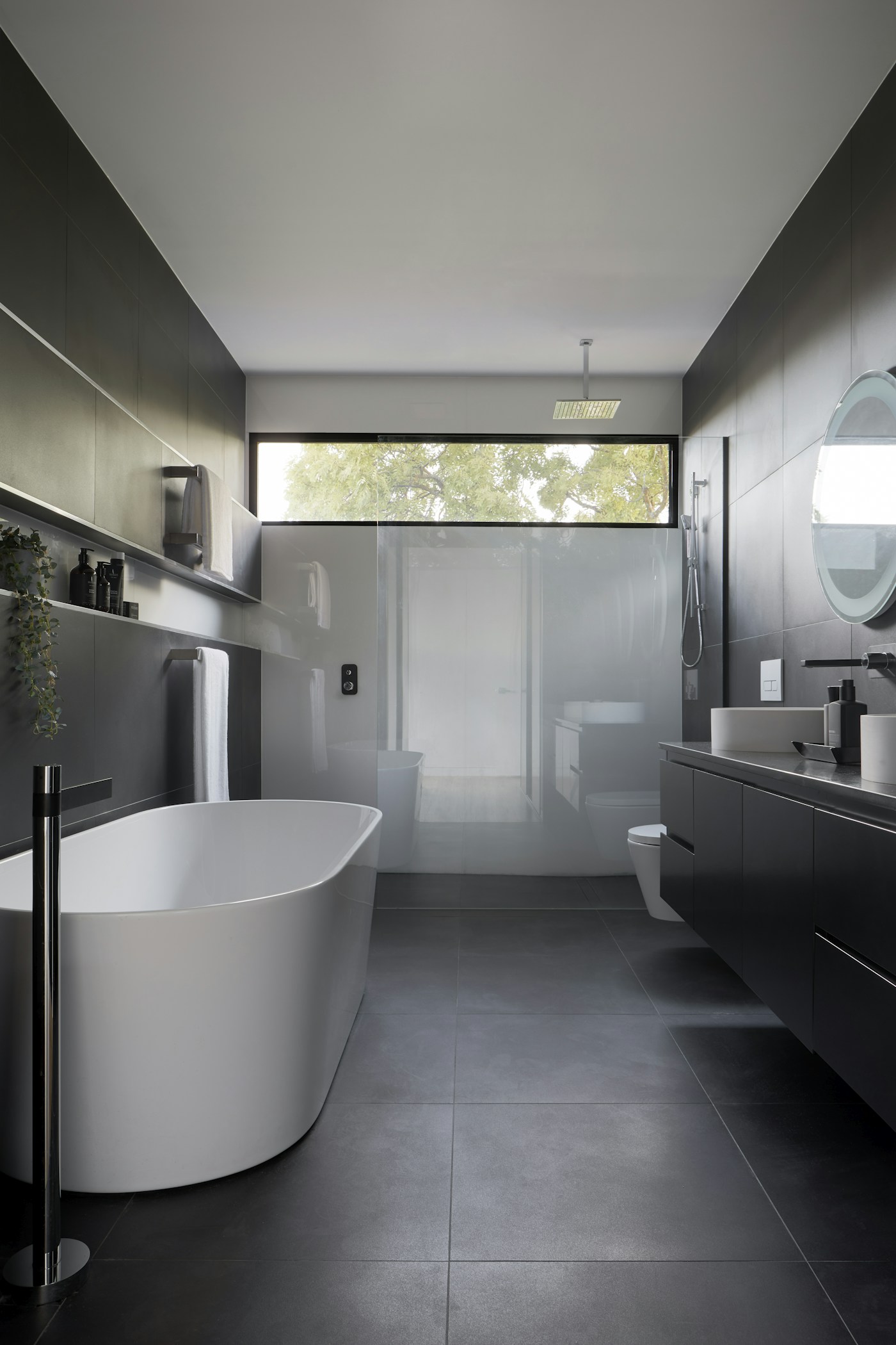 Luxury monochrome bathroom with freestanding bath and double vanity